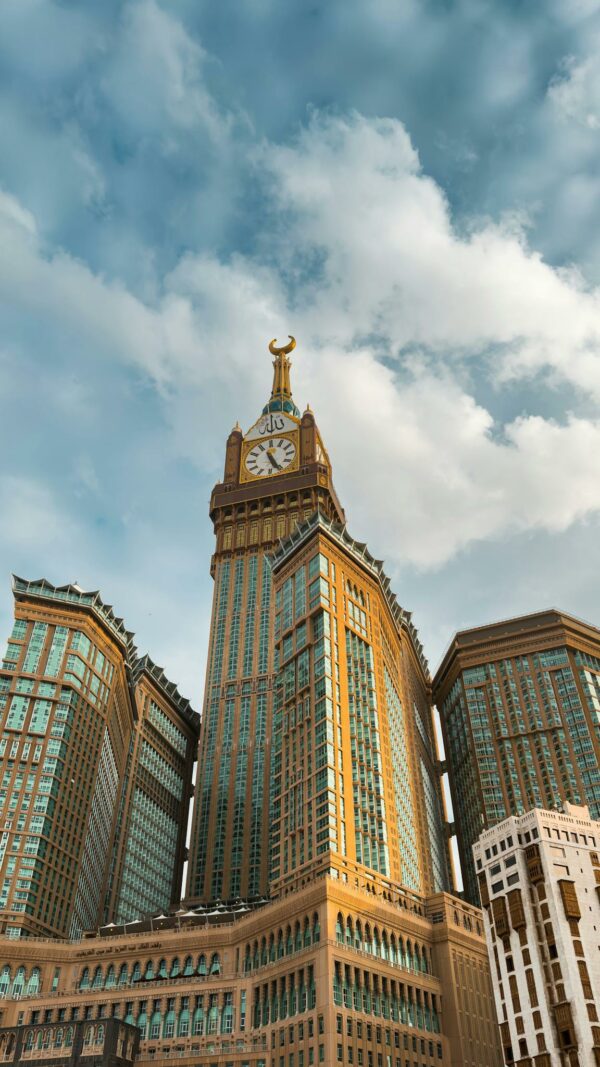 Capture of the magnificent Abraj Al Bait clock tower under a clear blue sky in Makkah, Saudi Arabia.